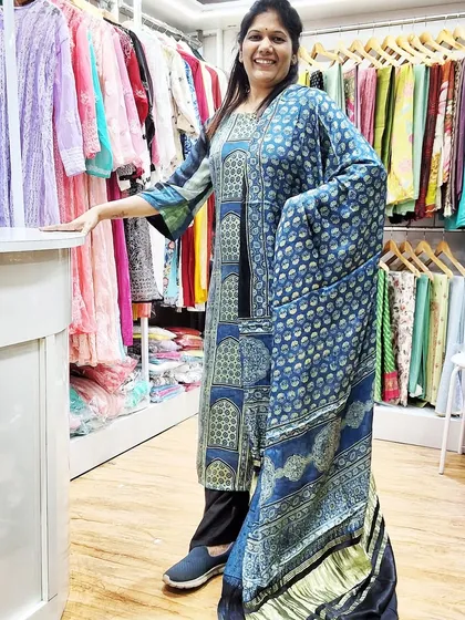 A customer looking radiant in a custom-stitched long kurti made from our modal Ajrakh fabric. We provide fabric as a 2-piece set (top and dupatta) which you can get tailored to your style.