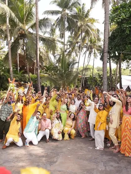 A group photo with the entire enthusiastic crowd at a Goa destination wedding. Capturing these moments of collective joy is what it's all about.