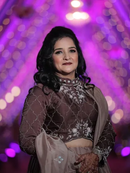 A poised portrait of the mother of the bride. Her elegant makeup and hair are the perfect complement to her sophisticated Sangeet outfit.