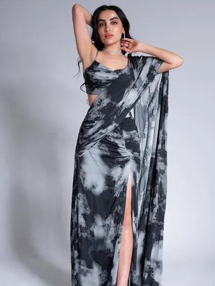 A full-length shot from the Label Shivani Nirupam campaign, showing a modern take on a draped saree with clean, elegant makeup.