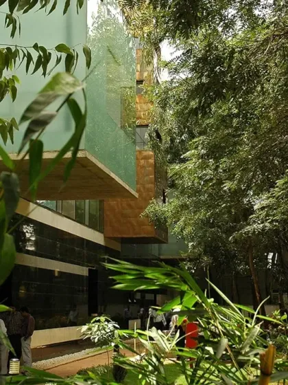 The dense landscaping surrounding the HP Campus in Bengaluru is integral to the design. The building is nestled within its green context, offering verdant views from every window and breaking down the barrier between office and nature.