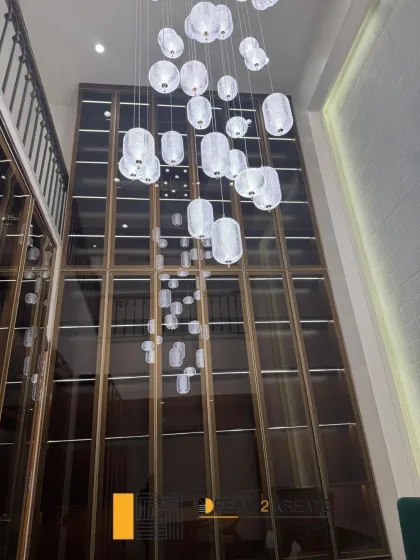 A shot looking up at the stunning, multi-story cascading light fixture in the Defence Colony law office. This feature piece was designed to create a sense of awe and modern elegance.