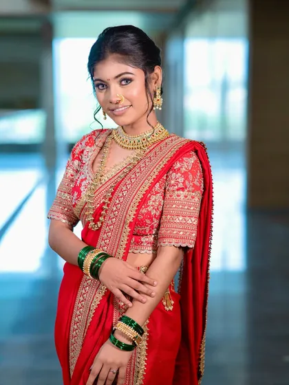 A happy bride, her smile lighting up the frame. The makeup is kept subtle and elegant, focusing on a radiant, healthy-looking complexion.