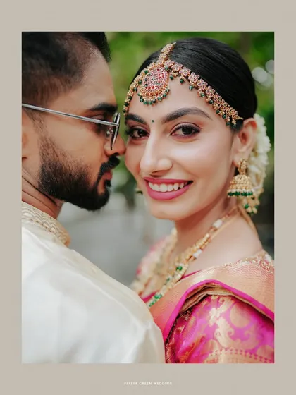 A beautiful close-up of the bride and groom, her radiant smile directed at the camera, capturing a moment of shared happiness.