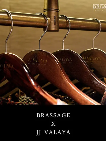 A close-up of the custom hanger rod, showing how it seamlessly integrates with the JJ Valaya branded wooden hangers. This is an example of my commitment to creating a complete, cohesive hardware solution for commercial projects.