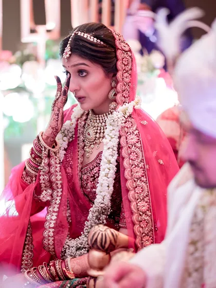 A single tear holds a thousand emotions. This candid shot captures the bride in a moment of overwhelming feeling during her wedding ceremony, a beautiful and honest expression of the day's significance.