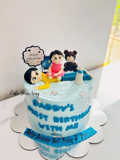 A sweet cake celebrating a dad's first birthday with his little one.