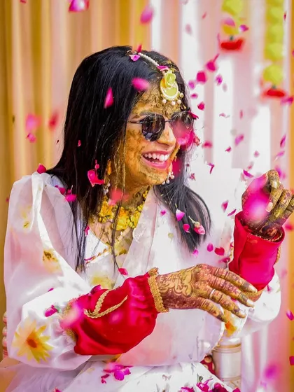 The Haldi ceremony is all about unrestrained joy. This candid shot of the bride, showered in flower petals and laughter, perfectly captures the fun and vibrant spirit of pre-wedding festivities. I look for these moments of pure happiness to add life and energy to your wedding story.