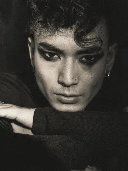 An intense close-up in black and white, focusing on the model's expressive eyes and the smudged, smokey-eye makeup. This portrait is all about raw emotion and attitude.
