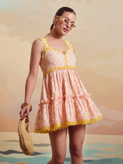 A closer shot of the Schiffli Sailor Dress, focusing on the vibrant yellow lace details and printed fabric.