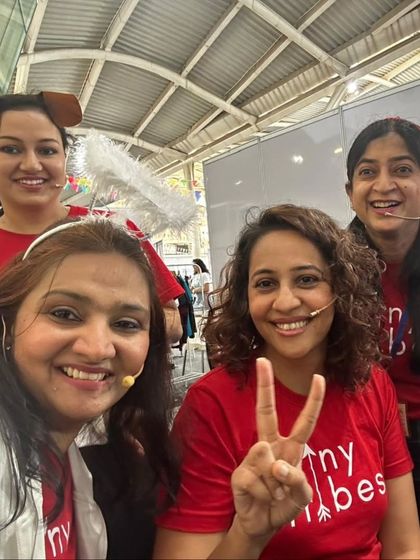 A happy selfie of our team backstage at the Kukdukoo Fest. We are all smiles after a successful performance, wearing our matching red Tiny Tribes shirts and fun character headbands. This is our tribe, full of passion and joy.