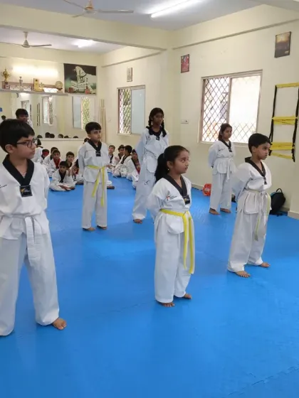 A group of yellow belts in their ready stance.