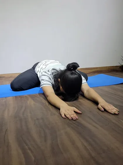 The child's pose is a restorative posture I use in almost every session. It's a simple but powerful way to gently stretch the back, hips, and thighs, and to calm the mind after a tough workout.