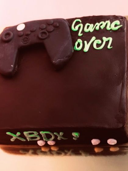 Game over for the single life! This Xbox-themed cake is a fun and creative choice for a bachelor party or a gamer's birthday.