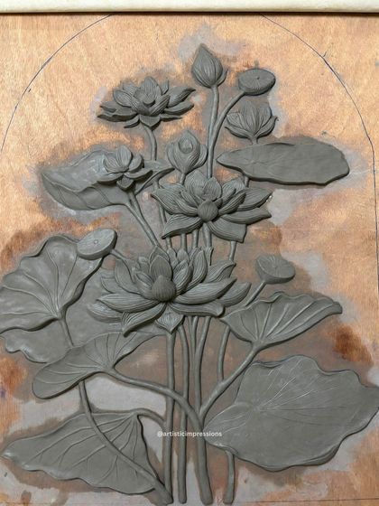 This is the first stage of the Lotus mural, sculpted entirely from clay. At this point, the focus is on establishing the composition, flow, and balance of the piece before it is cast and refined.