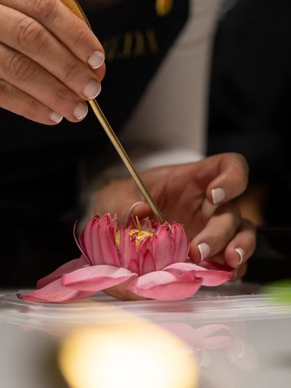 A student delicately places the final petal on a sugar lotus flower, a stunning garnish from our Indian-inspired plated desserts masterclass.
