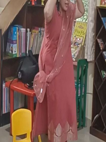 A storyteller acts out a character with great enthusiasm, using her whole body to tell the story.