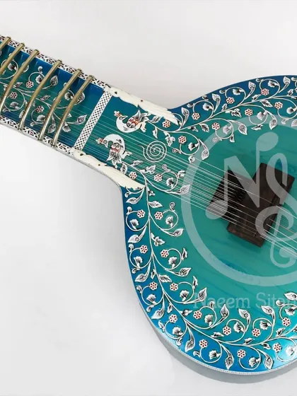 This is our blue rock peacock color design sitar. It features beautiful floral inlay work across the body and neck, with a stunning blue finish.