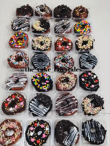 Another look at a large assortment of my baked mini donuts. This batch shows a mix of dark chocolate, milk chocolate, and various sprinkle combinations, perfect for any event.