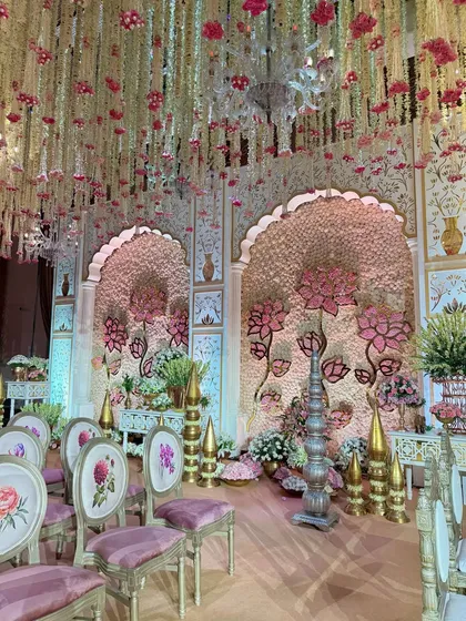 A view of the mandap from the guest seating area. The custom-printed chairs and the grand stage create a cohesive and luxurious experience for everyone in attendance.