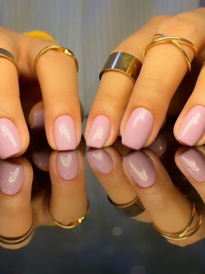 A full view of the pretty pastel pink manicure.