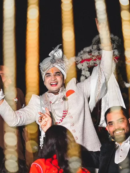 The groom's energy is infectious in this candid shot from the baraat. We get right into the action to capture the excitement and joy of the groom's procession.