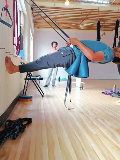 This advanced practice uses wall ropes to decompress the spine and build incredible core strength. It's a therapeutic approach to building a strong back.