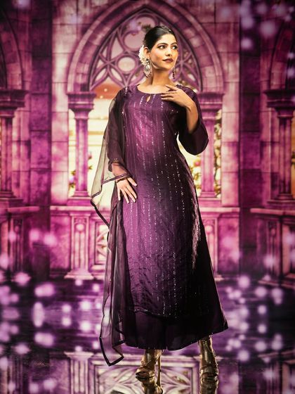 A magical, purple-hued palace is the projected backdrop for this elegant portrait. The lighting complements the fantasy theme, creating a dreamy and enchanting image.