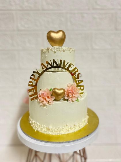 A clean shot of the mini three-tier cake, showing the floral and gold details.