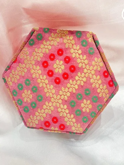A custom hexagonal wedding jewelry box in a pink and gold brocade fabric. A beautiful keepsake for the bride or bridesmaids.