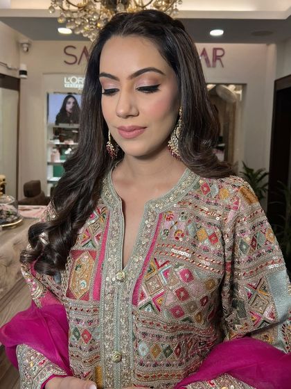 Eyes closed, highlighting the soft pink and brown tones on the eyelids, creating a subtle yet glamorous effect.