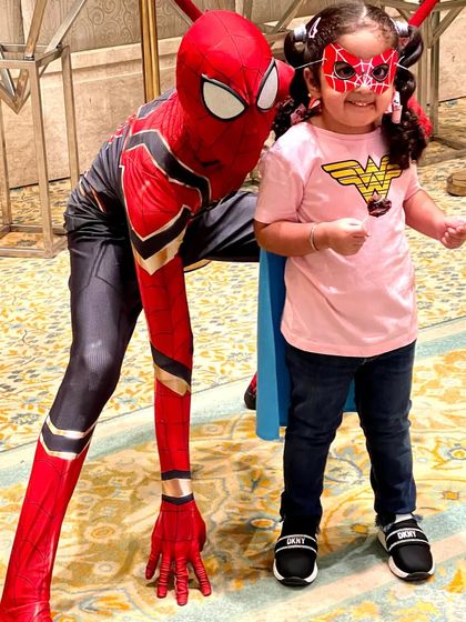 A young fan dressed as Wonder Woman meets her hero, Spiderman. We love creating these special moments of connection between our characters and your kids.