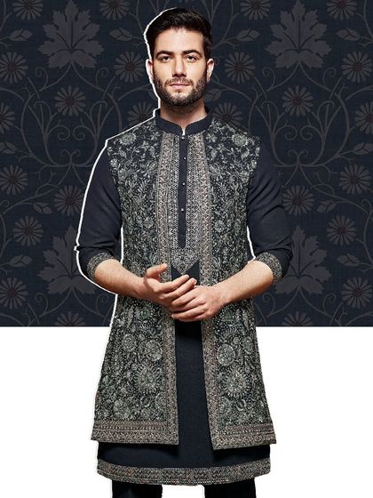 A close-up view of our embroidered open jacket, revealing the precision of the silver threadwork against a dark base. This is a versatile piece for creating a statement look.