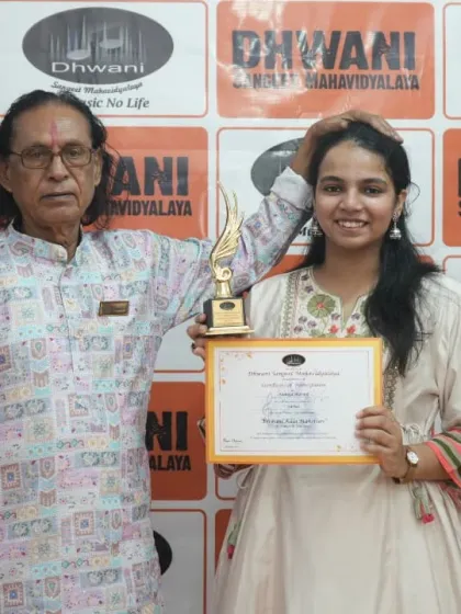 An adult student with her guru after receiving her award.