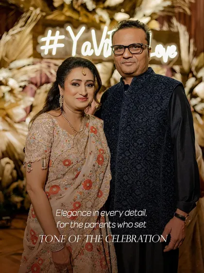 Elegance in every detail for the parents who set the tone of the celebration. For this event, the mother of the groom wears a beautiful Anamika Khanna ensemble, while the father is dapper in a classic bandhgala. Their style provides a graceful anchor for the entire family's look.
