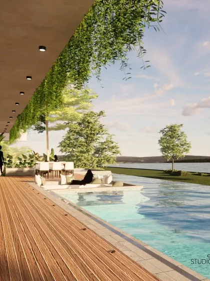 This waterfront residence is designed to dissolve the boundaries between the home and the Gurupura river. A handcrafted wooden deck and an infinity pool create a continuous plane of water and wood, offering a tranquil space for relaxation and social gatherings.