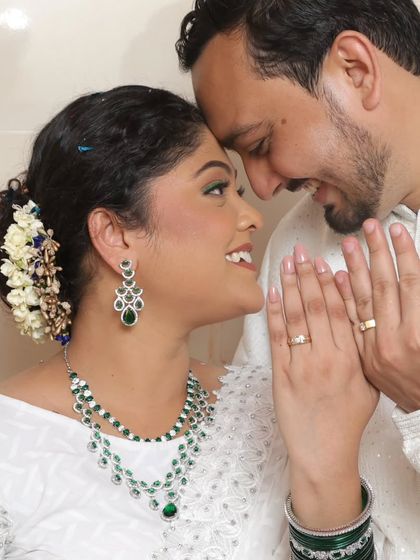 A happy customer looking radiant on her engagement day in my green AD double-layer necklace.