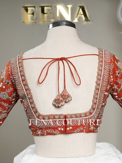 My signature Katori blouse in a festive burnt orange. This piece features contemporary silver and white floral embroidery on the sleeves, with delicate pearl detailing scattered across the body for a touch of bling.