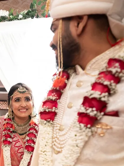 A candid shot of the bride looking at her groom as they walk, capturing a natural, in-between moment.