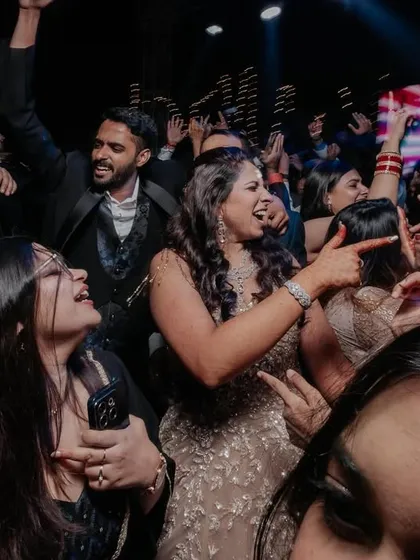 A close-up shot from the middle of the dance floor, capturing the happy, crowded energy of the party.