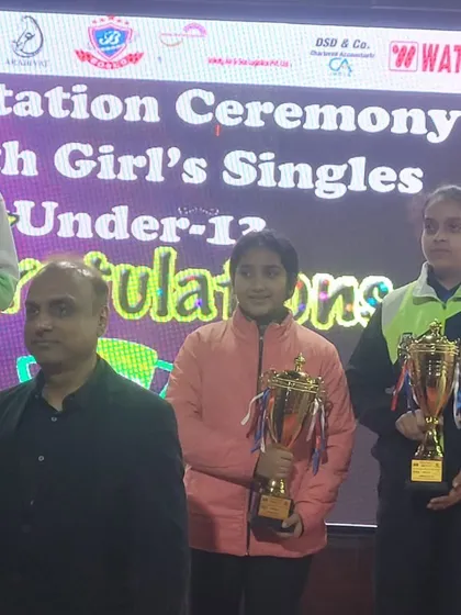 Akanksha Singhal holding her trophy after a strong performance in the Under-13 Girls' Singles at the Delhi State Championship.