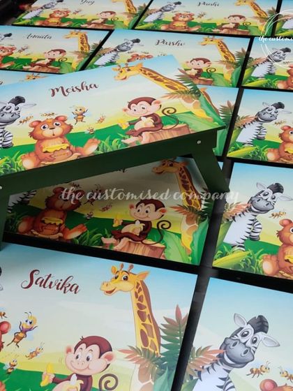 Foldable and personalized study desks for your little monkeys. These tables can be curated with any theme, like this jungle animal design, and are perfect as return gifts for birthday parties.