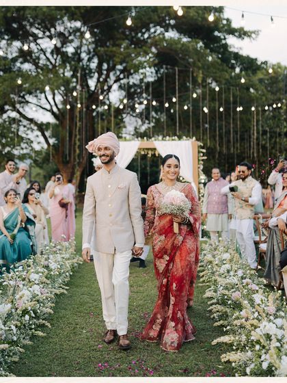 The joyful exit. This photo captures the pure happiness of a newly married couple as they walk down the aisle, showered with love from their guests. It's a classic moment, captured with genuine energy.