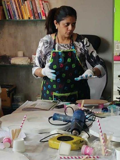 I believe in giving personal attention to each student. Here, I'm discussing color mixing and techniques during a group session to ensure everyone is confident in what they are creating.