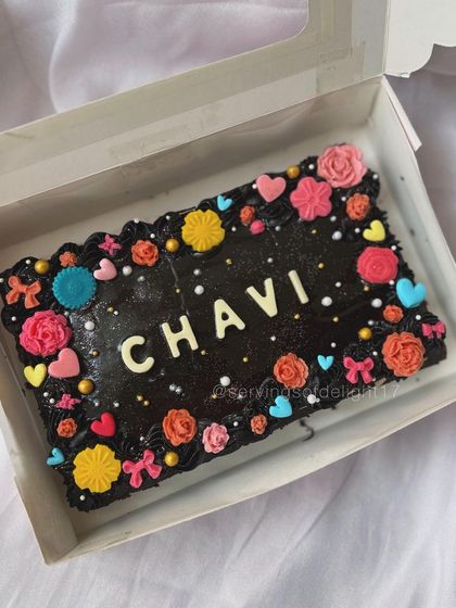 A pretty and colorful sheet cake for Chavi's birthday. This fudgy chocolate cake is decorated with a border of vibrant, handmade flowers and hearts.