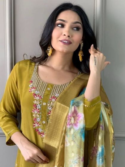 A beautiful mustard viscose chanderi kurta set. The thread embroidery on the neckline and the printed dupatta create a look that's both traditional and trendy.
