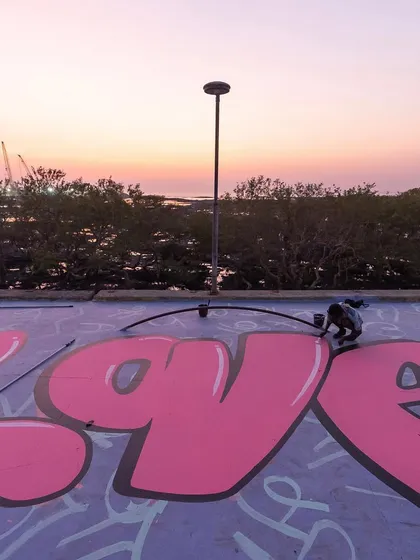 Painting a large pink 'LOVE' throw-up as the sun sets over the mangroves at Carter Road. The location was as much a part of the art as the paint itself.