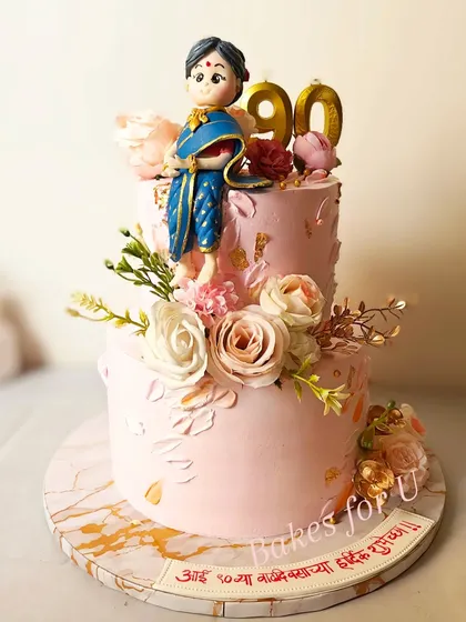 Another view of the stunning 90th birthday cake, highlighting the detailed fondant work and the elegant arrangement of fresh flowers.