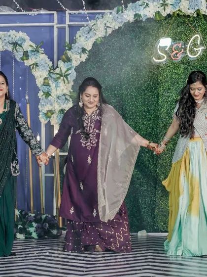 A coordinated move from the ladies' group dance. Even simple hand-holding steps can look beautiful when done together.