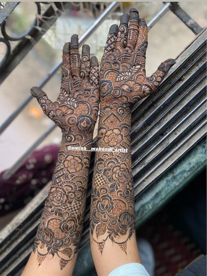 The back of a full bridal design, showcasing the intricate patterns that cover the arms from wrist to elbow.